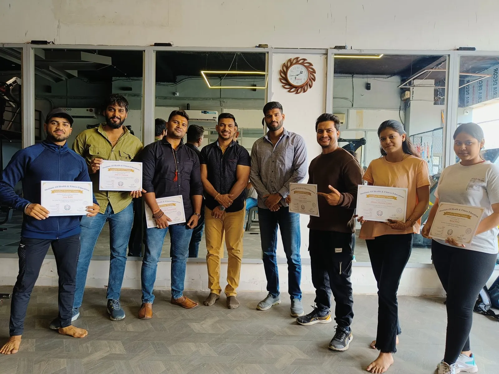 IHFE graduating batch holding their Certified Personal Trainer and Certified Massage Therapist certificates with their instructors
