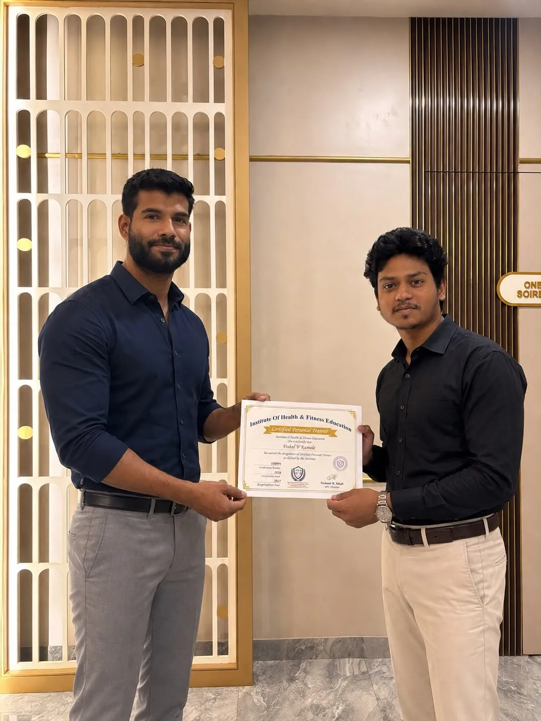 IHFE graduate receiving a Certified Personal Trainer certificate